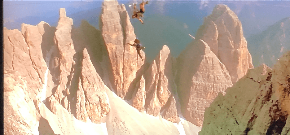 A canyon with a mountain in the background

Description automatically generated