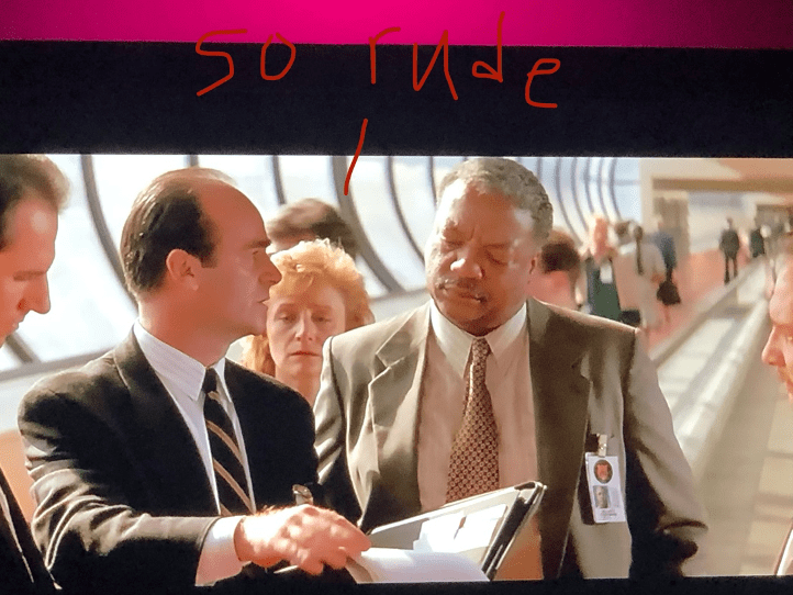 A screen shot of a person in a suit and tie

Description automatically generated